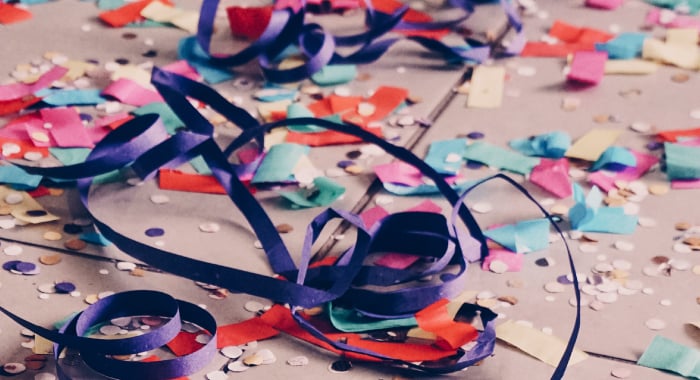 confetti, streamers, and balloon ribbons on the ground