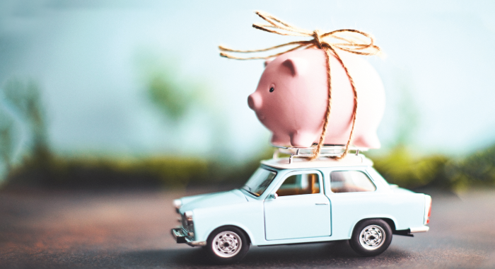 Piggy bank tied to the roof of a car