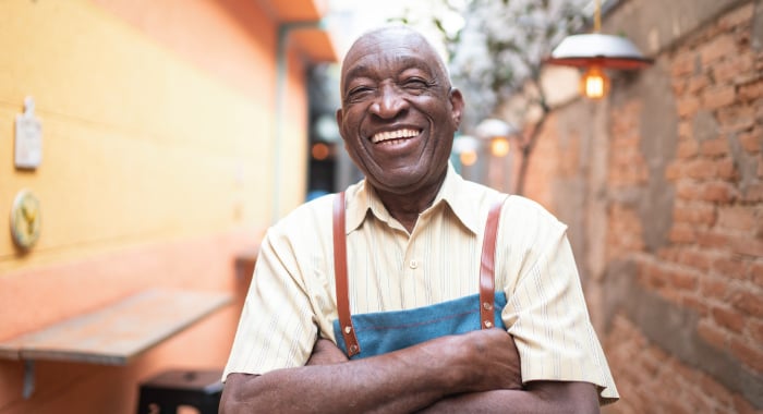 Person smiling at camera with arms crossed