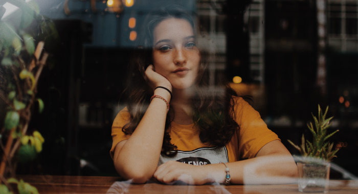 person looking at the camera through a window