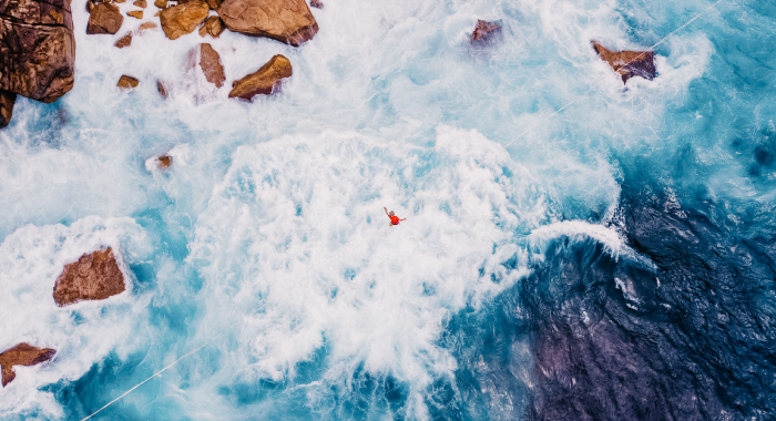 person jumping off a cliff for sport