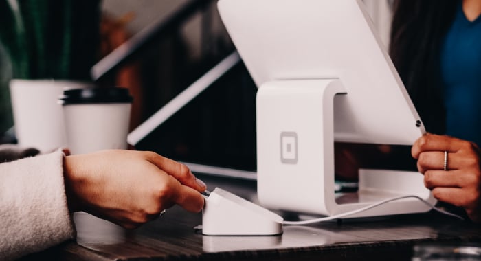 Person paying at a register using a card