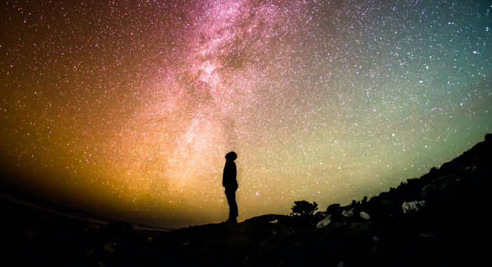 Person staring up at the stars