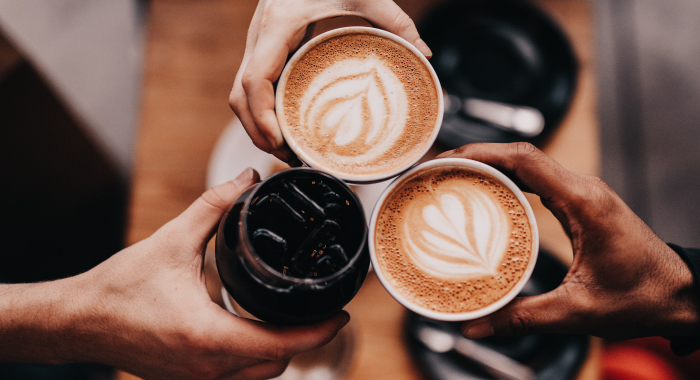 People holding coffee cups together