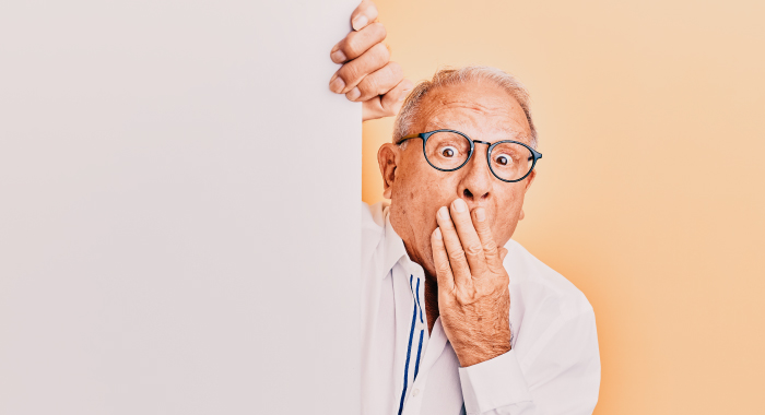 Man holding his hand over his mouth in surprise