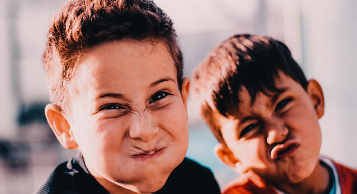 Two children making funny faces