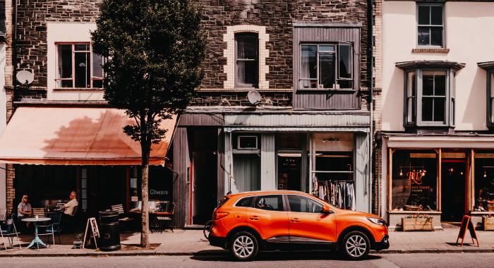 orange car parked outside a building