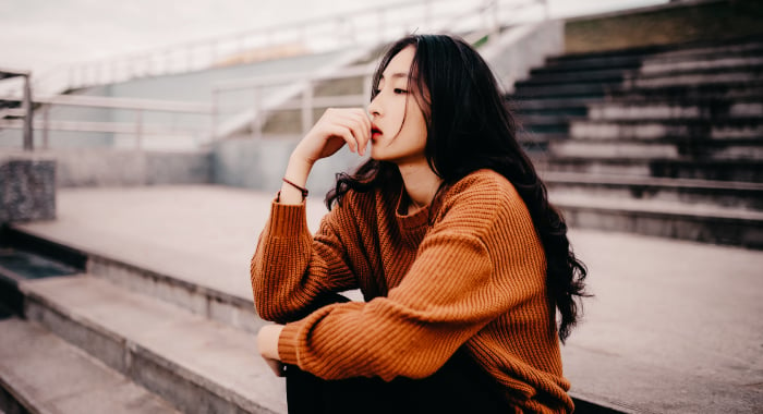 woman sitting and staring out in front of her