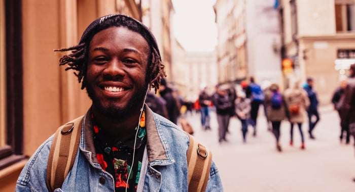 Person walking on the street and smiling