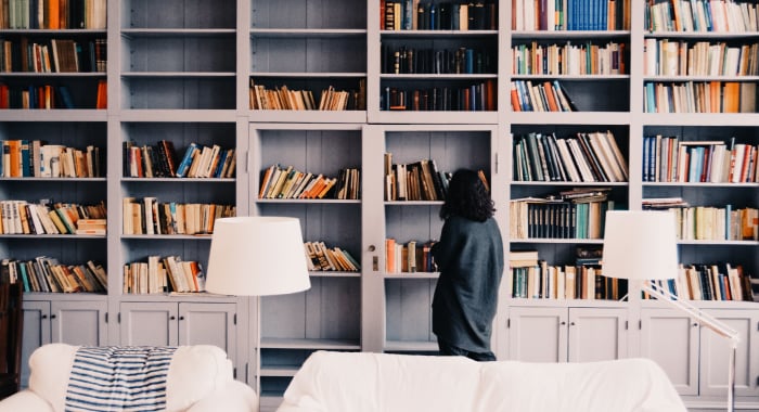 person looking at a large bookcase