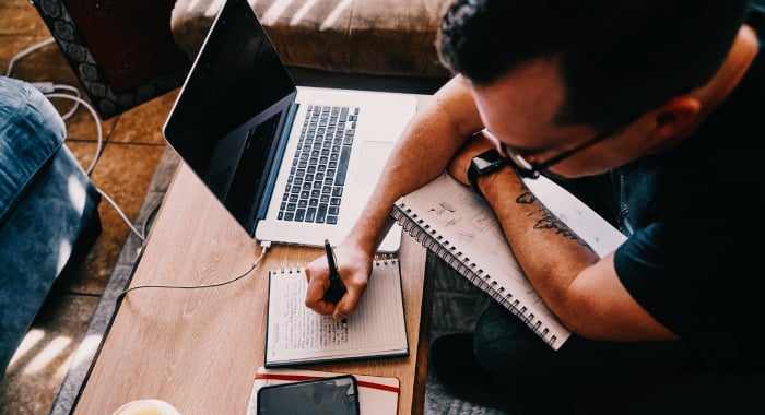 person writing in a notebook