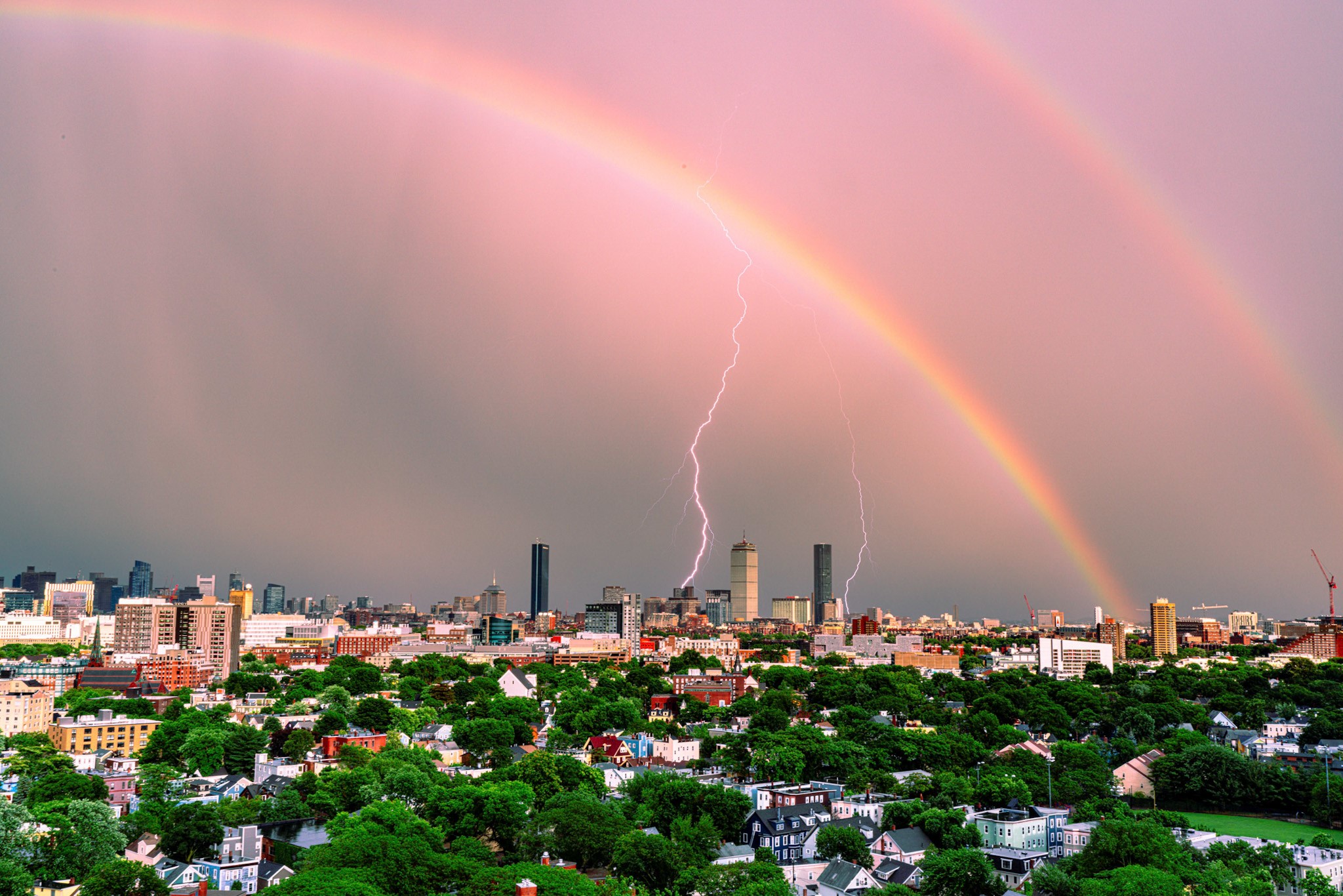 double rainbow and lightning over Boston skyline