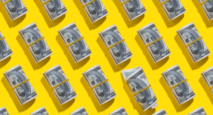 Dollar bill rolls on a yellow background