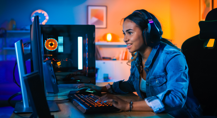 Young girl with headphones on her computer