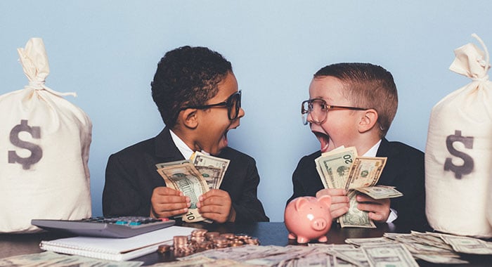 two young children holding money