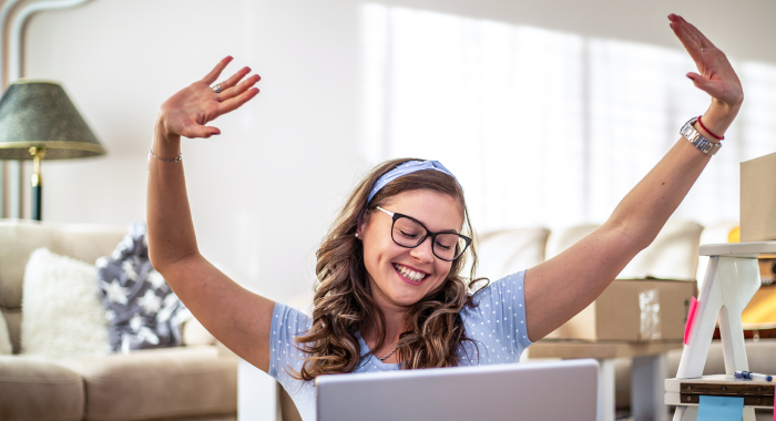 Person celebrating at their computer