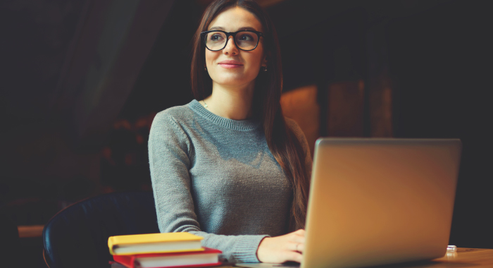 student sitting at their laptop